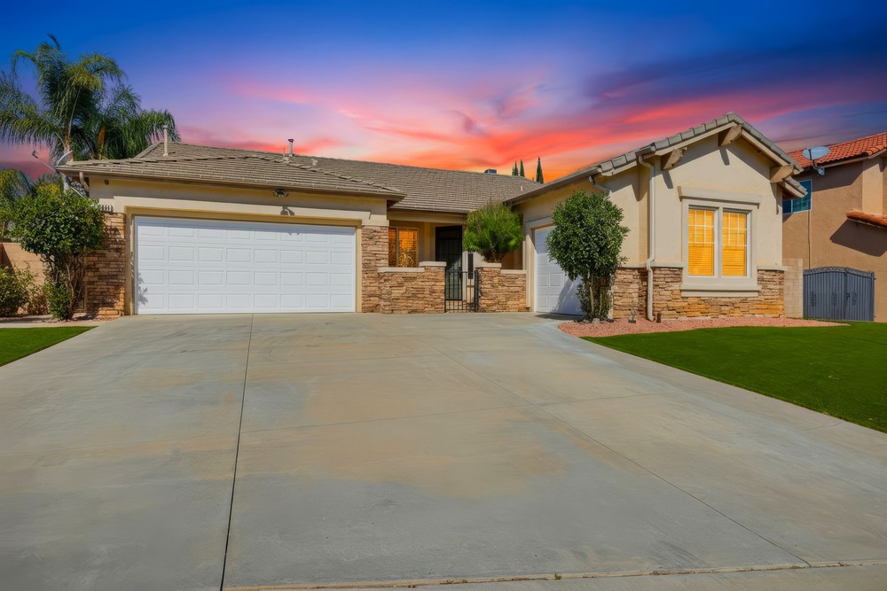 Exterior of the Casera Court home in Menifee, California, at dusk with warm interior lighting