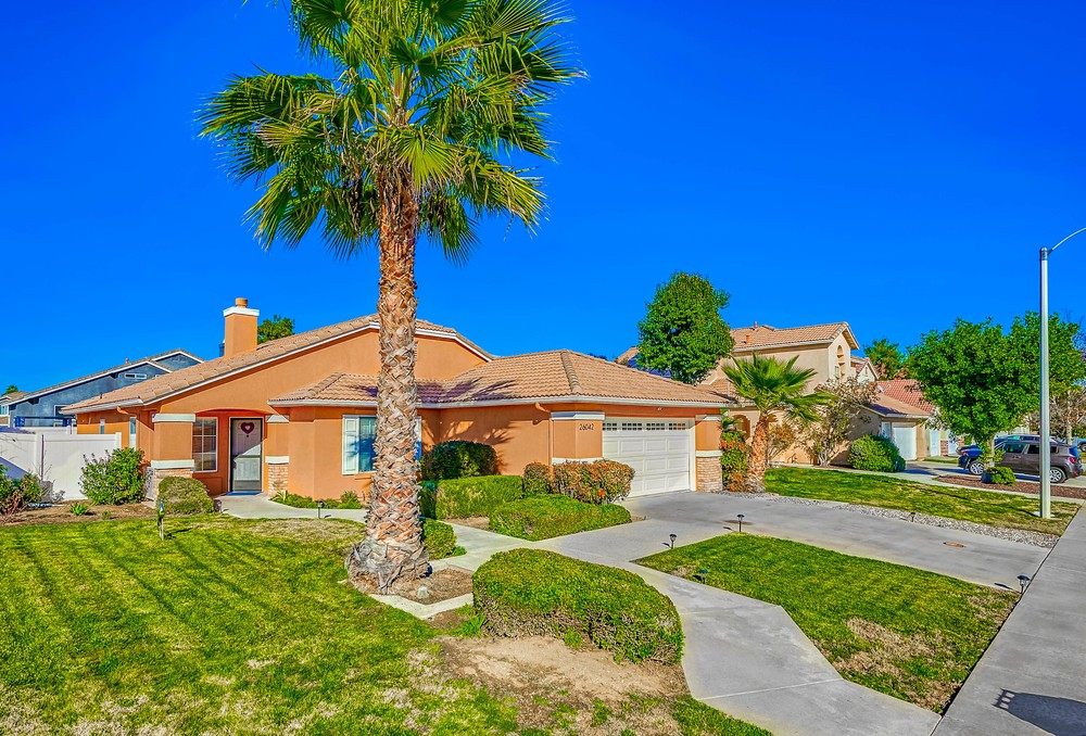 Exterior of the Westridge home, a single-story stucco house with a tile roof